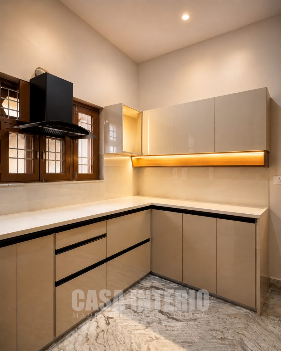 Modular kitchen in champagne laminate with under-cabinet lighting