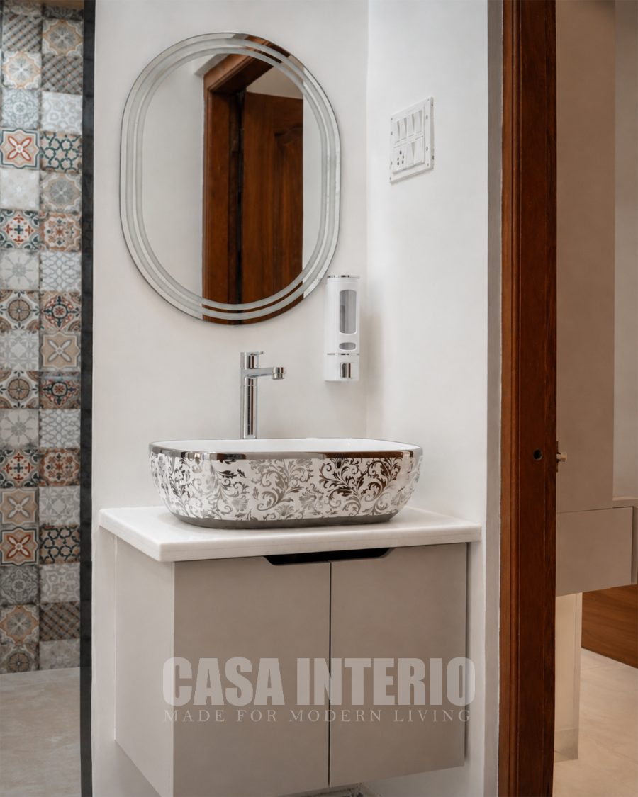 Powder room vanity with patterned tile and oval mirror