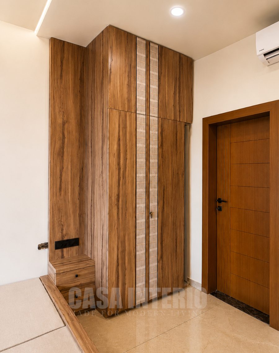 Full-height wooden wardrobe and shoe bench in an entryway